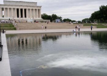 America@250 swathed in crimson, white, and blue — and inexperienced algae